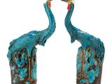pair of blue and green bird sculptures on a white background