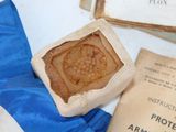 a wax seal sitting on a piece of paper next to a book