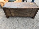 an old wooden chest sitting on the gravel