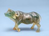 a glass figurine of an elephant on a blue background