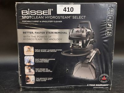 the box of the bissell spotclean hydrant cleaner is open