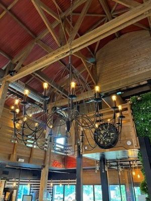 a chandelier in the middle of a restaurant with lots of lights