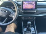 a picture of a car dashboard with a monitor in it