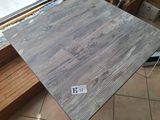 a picture of a piece of wood sitting on a tile floor