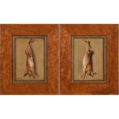two framed pictures of a pair of rabbits hanging on a wall