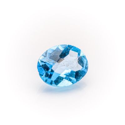 a close up of a blue topazte gems on a white background