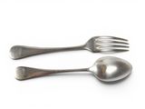 two spoons and a fork on a white surface
