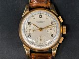 a close up of a wrist watch with a brown leather strap