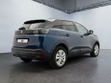 the rear end of a blue car parked in a garage