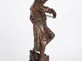 a bronze statue of a man with a dog on a pedestal