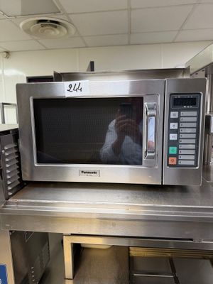 a microwave that is sitting on a table in a kitchen