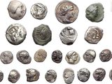 a close up of a bunch of silver coins on a white surface