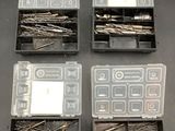 four plastic boxes filled with assorted metal pins and screws