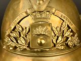 a gold helmet with a crest and a crown on it