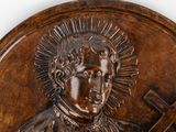 a close up of a plaque of a man with a cross