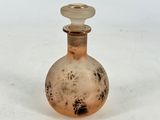 a small glass bottle that is sitting on a table