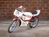 a motorcycle that is parked in front of a brick wall