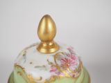 a green and gold covered dish with a gold lid
