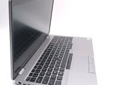 a silver laptop computer sitting on top of a white table