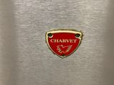 a close up of a red badge on a silver oven