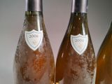 three bottles of wine sitting on top of a table next to each other