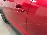 a close up of a car door handle with a sticker on it