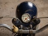 a close up of a motorcycle handlebar with a speedometer on it