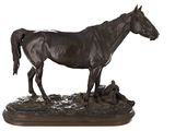 a statue of a horse that is standing on a rock