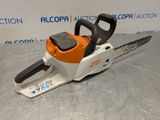 a chainsaw is sitting on a table with a sign in the background