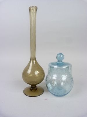 two glass vases sitting next to each other on a table