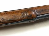 an old rifle with a wooden handle on a white surface