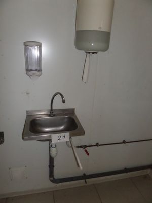 a sink and a faucet in a small room