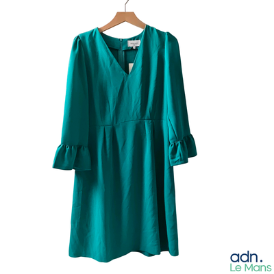 an image of a green dress hanging on a hanger