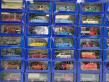 a lot of toy cars that are in a blue box