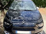 the front of a black citrole parked on a gravel road