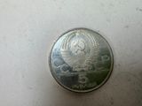 a silver coin with a picture of a woman on it