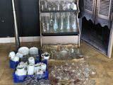 many empty glasses and containers on the floor in the kitchen