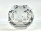 a clear glass vase that is sitting on a white surface