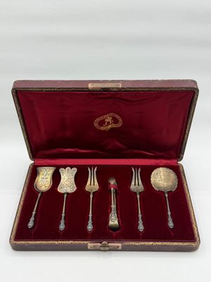 an antique silverware set in a case with a red velvet lining