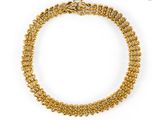 a gold chain bracelet with a clasp on a white background