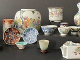 many different types of vases and bowls on the table