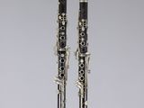 a pair of clarinets sitting on top of a white surface