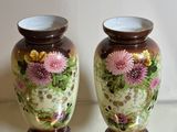 two vases that are sitting on a table