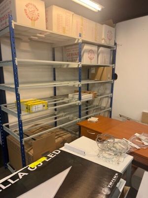 a room with a lot of shelves and boxes on it