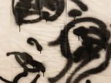a black and white photo of a graffiti on a wall