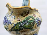 a vase with a dragon painted on it on a table