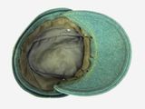 a green hat that is sitting on top of a table