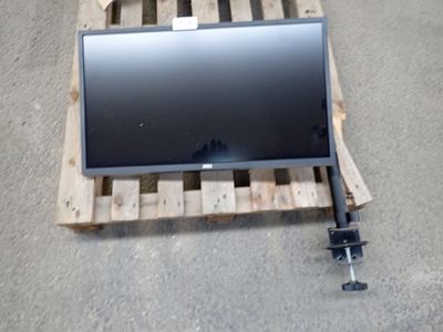 a computer monitor sitting on a pallet on the floor