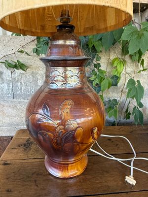 a lamp that is sitting on a table next to a plant