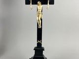 a statue of jesus on a cross with a cross in the background